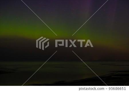 Intense northern lights aurora borealis over beach in Riga, Latvia. Defocused Intense northern lights aurora borealis over beach in Riga, Latvia. Defocused 93686651