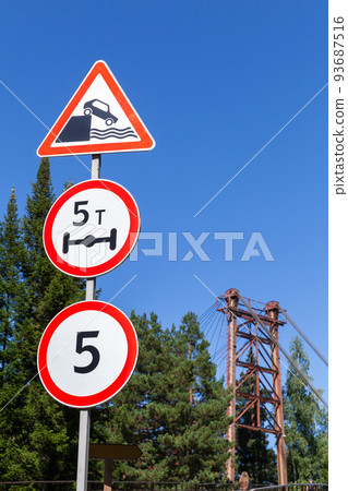 Road signs mounted at the entrance of a bridge Road signs mounted at the entrance of a bridge 93687516