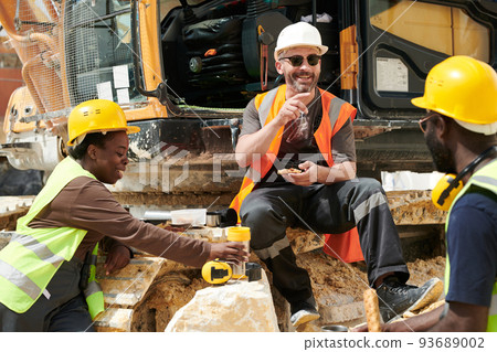 Group of happy middle aged intercultural workers of marble quarry having lunch 93689002