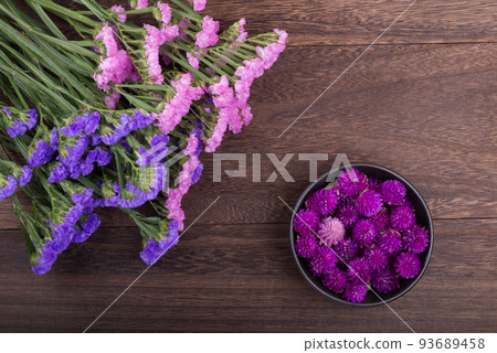 Bicolor red snapper and crape myrtle flowers on a wooden table Bicolor red snapper and crape myrtle flowers on a wooden table 93689458