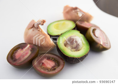 vegetables black tomatoes, avocado and onions on white background vegetables black tomatoes, avocado and onions on white background 93690147