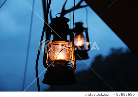 Camping sunset with oil lanterns under the tarp 93692690
