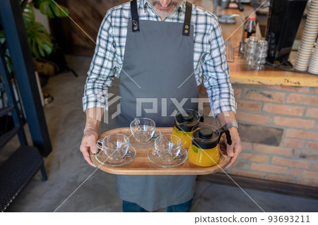 Bartender serving citrus drinks at a bar 93693211