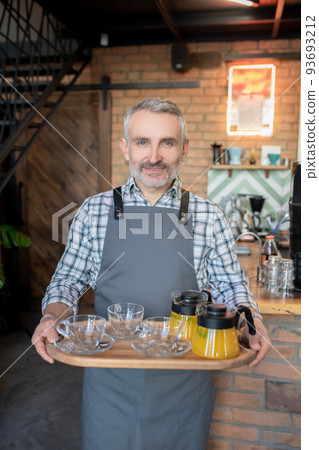 Barman serving citrus drinks to his clients Barman serving citrus drinks to his clients 93693212