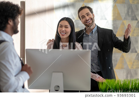 Young manager welcoming new employee and looking positive 93693301