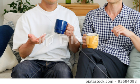Male couple talking in the living room Faceless Male couple talking in the living room Faceless 93694098