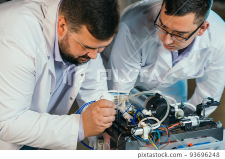 Two scientists are working on the development of a new device 93696248