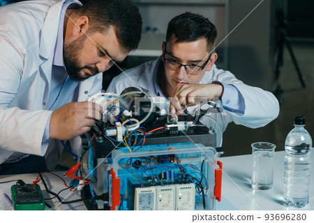 Two scientists are working on the development of a new device 93696280
