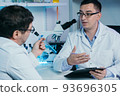 Researcher writes down the results of research in a laboratory journal. 93696305
