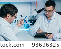 Researcher writes down the results of research in a laboratory journal. 93696325