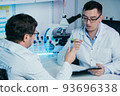 Researcher writes down the results of research in a laboratory journal. 93696338