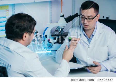 Researcher writes down the results of research in a laboratory journal. 93696338