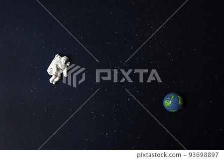 Spaceman and Earth on space background Spaceman and Earth on space background 93698897