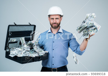 cheerful mature man businessman in building hard hat hold money case with dollar cash, income cheerful mature man businessman in building hard hat hold money case with dollar cash, income 93699318