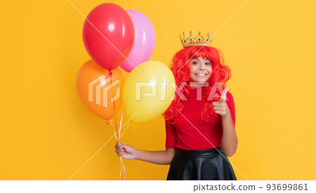 happy child in crown with party balloon on yellow background happy child in crown with party balloon on yellow background 93699861