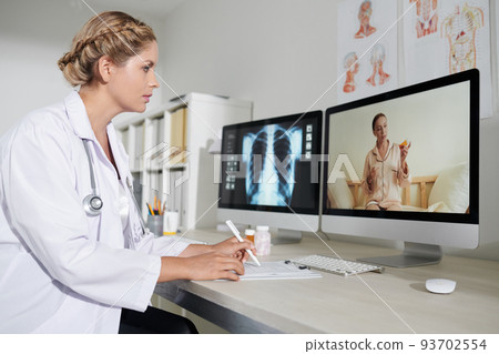 General practitioner talking to sick patient and writing down complains General practitioner talking to sick patient and writing down complains 93702554
