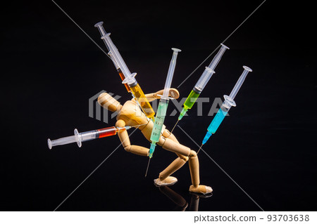Composition of wooden mannequin with stucked syringes on black background. Drug addiction concept. Composition of wooden mannequin with stucked syringes on black background. Drug addiction concept. 93703638
