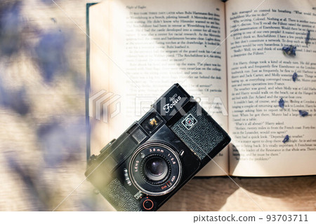 Dried flowers, foreign books and a camera Dried flowers, foreign books and a camera 93703711
