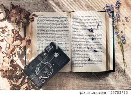 Dried flowers, foreign books and a camera 93703713