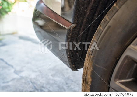 Tarmac and mud stains on rear of black plastic bumper car 93704075