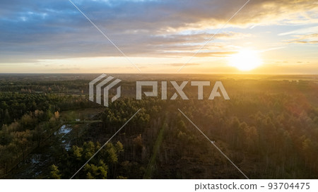 Beautiful sunset over a river with green bushes and color rich sky Beautiful sunset over a river with green bushes and color rich sky 93704475