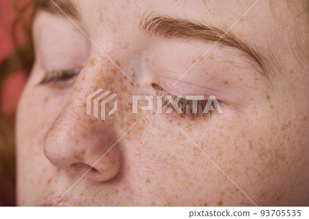 Close-up of young red haired girl with clean face with freckles Close-up of young red haired girl with clean face with freckles 93705535