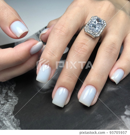 White manicure. Hands of a woman with white manicure on nails.Manicure beauty salon concept. Empty place for text or logo. White manicure. Hands of a woman with white manicure on nails.Manicure beauty salon concept. Empty place for text or logo. 93705937