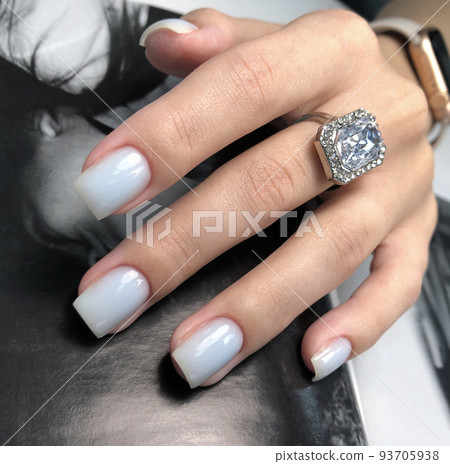 White manicure. Hands of a woman with white manicure on nails.Manicure beauty salon concept. Empty place for text or logo. 93705938