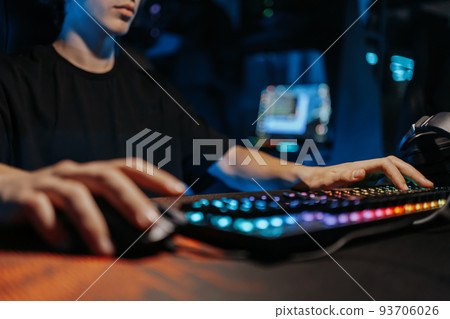 A professional e-sportsman plays games. Incognito Hacker. A professional e-sportsman plays games. Incognito Hacker. 93706026