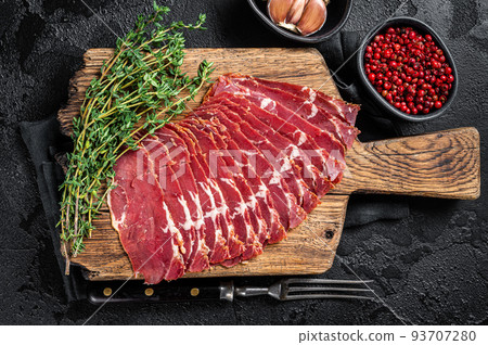 Sliced Turkish bacon Pastrami, roasted beef meat. Black background. Top view 93707280