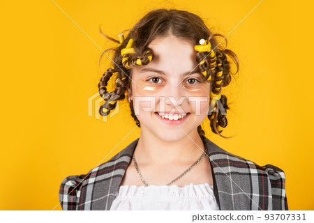 small girl has hair curlers papillotes. kid hairdresser salon. healthy long hairstyle. hair care for child. little woman grooming with hair roller. eye therapy patch. beauty and fashion 93707331