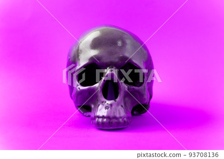 Halloween holiday concept. Scary skull on purple background. Selective focus Halloween holiday concept. Scary skull on purple background. Selective focus 93708136