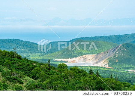 landscape of Kunashir Island, geothermal lakes among lava domes in the center of Golovnin volcano caldera; the island of Hokkaido is visible in the distance in the sea landscape of Kunashir Island, geothermal lakes among lava domes in the center of Golovnin volcano caldera; the island of Hokkaido is visible in the distance in the sea 93708229