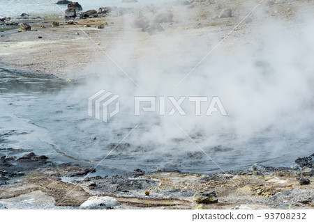 boiling and steaming hydrothermal outlet on the shore of the hot lake in the caldera of the Golovnin volcano on the island of Kunashir boiling and steaming hydrothermal outlet on the shore of the hot lake in the caldera of the Golovnin volcano on the island of Kunashir 93708232