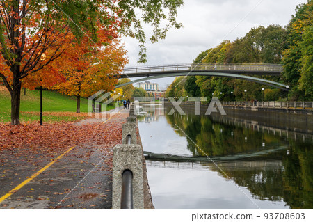 Fall foliage in Ottawa, Ontario, Canada. Rideau Canal Eastern Pathway autumn red leaves scenery. The Corktown Footbridge. Fall foliage in Ottawa, Ontario, Canada. Rideau Canal Eastern Pathway autumn red leaves scenery. The Corktown Footbridge. 93708603