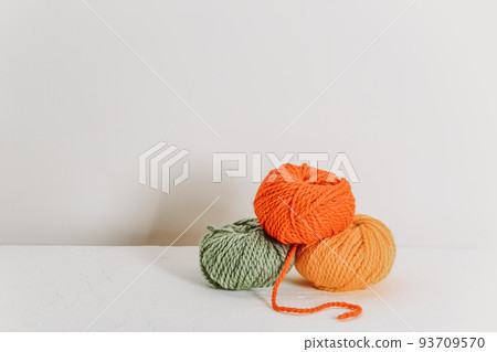 Knitting balls in autumn colors. Place for text Knitting balls in autumn colors. Place for text 93709570