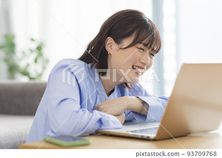 A young lady watching a computer A young lady watching a computer 93709768