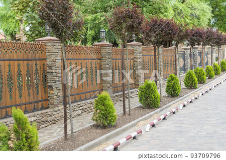 decorated sidewalk road by a beautiful fence decorated sidewalk road by a beautiful fence 93709796