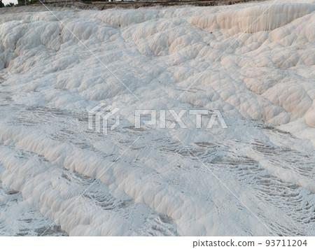 Pamukkale Travertines Cinematic Aerial Drone footage. Turkish famous white thermal bath with healthy clean water in a beautiful sunset.  93711204