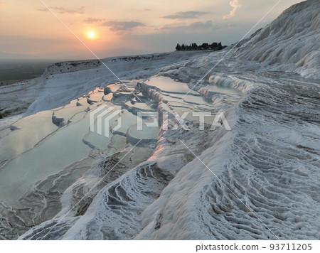 Pamukkale Travertines Cinematic Aerial Drone footage. Turkish famous white thermal bath with healthy clean water in a beautiful sunset.  93711205