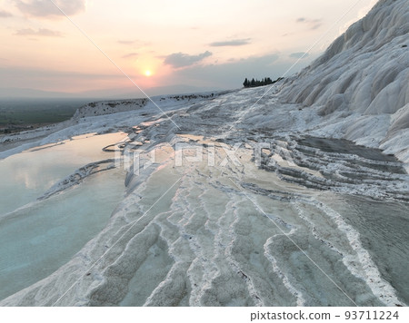Pamukkale Travertines Cinematic Aerial Drone footage. Turkish famous white thermal bath with healthy clean water in a beautiful sunset. Pamukkale Travertines Cinematic Aerial Drone footage. Turkish famous white thermal bath with healthy clean water in a beautiful sunset. 93711224