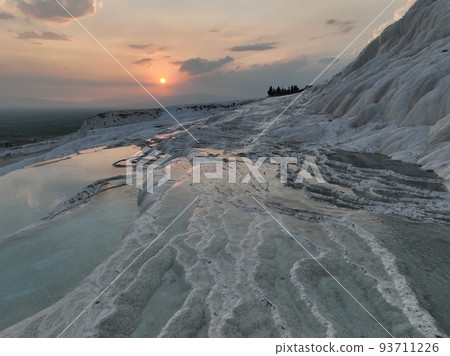 Pamukkale Travertines Cinematic Aerial Drone footage. Turkish famous white thermal bath with healthy clean water in a beautiful sunset. Pamukkale Travertines Cinematic Aerial Drone footage. Turkish famous white thermal bath with healthy clean water in a beautiful sunset. 93711226