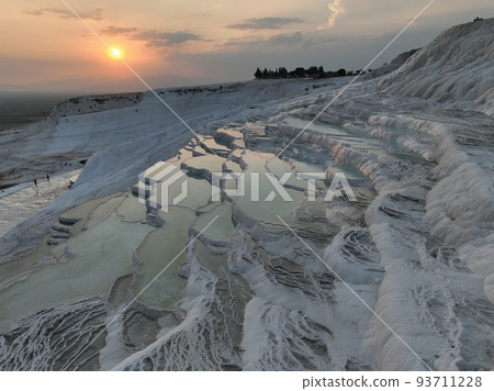 Pamukkale Travertines Cinematic Aerial Drone footage. Turkish famous white thermal bath with healthy clean water in a beautiful sunset. Pamukkale Travertines Cinematic Aerial Drone footage. Turkish famous white thermal bath with healthy clean water in a beautiful sunset. 93711228