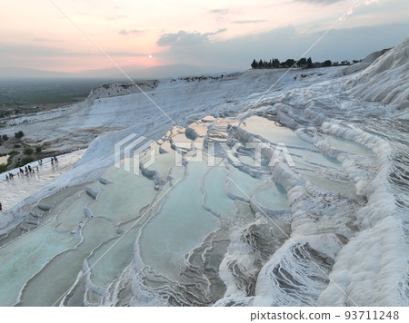 Pamukkale Travertines Cinematic Aerial Drone footage. Turkish famous white thermal bath with healthy clean water in a beautiful sunset.  93711248