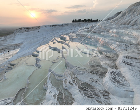 Pamukkale Travertines Cinematic Aerial Drone footage. Turkish famous white thermal bath with healthy clean water in a beautiful sunset. Pamukkale Travertines Cinematic Aerial Drone footage. Turkish famous white thermal bath with healthy clean water in a beautiful sunset. 93711249