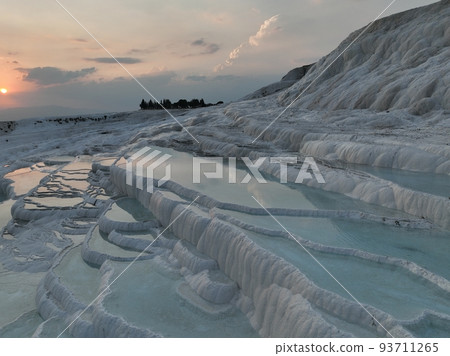 Pamukkale Travertines Cinematic Aerial Drone footage. Turkish famous white thermal bath with healthy clean water in a beautiful sunset. Pamukkale Travertines Cinematic Aerial Drone footage. Turkish famous white thermal bath with healthy clean water in a beautiful sunset. 93711265