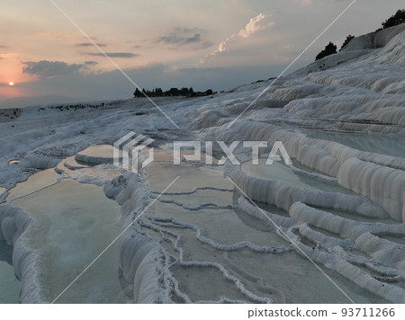 Pamukkale Travertines Cinematic Aerial Drone footage. Turkish famous white thermal bath with healthy clean water in a beautiful sunset. Pamukkale Travertines Cinematic Aerial Drone footage. Turkish famous white thermal bath with healthy clean water in a beautiful sunset. 93711266
