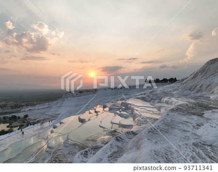 Pamukkale Travertines Cinematic Aerial Drone footage. Turkish famous white thermal bath with healthy clean water in a beautiful sunset.  93711341