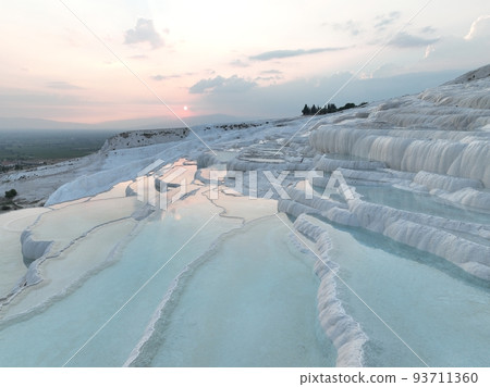 Pamukkale Travertines Cinematic Aerial Drone footage. Turkish famous white thermal bath with healthy clean water in a beautiful sunset. Pamukkale Travertines Cinematic Aerial Drone footage. Turkish famous white thermal bath with healthy clean water in a beautiful sunset. 93711360