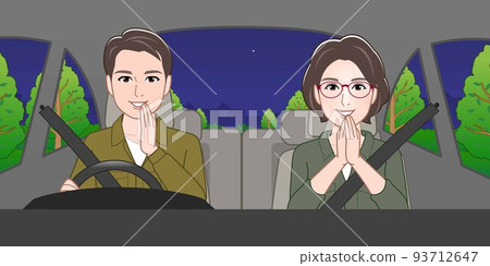 A man and a woman are riding in a car at night 93712647